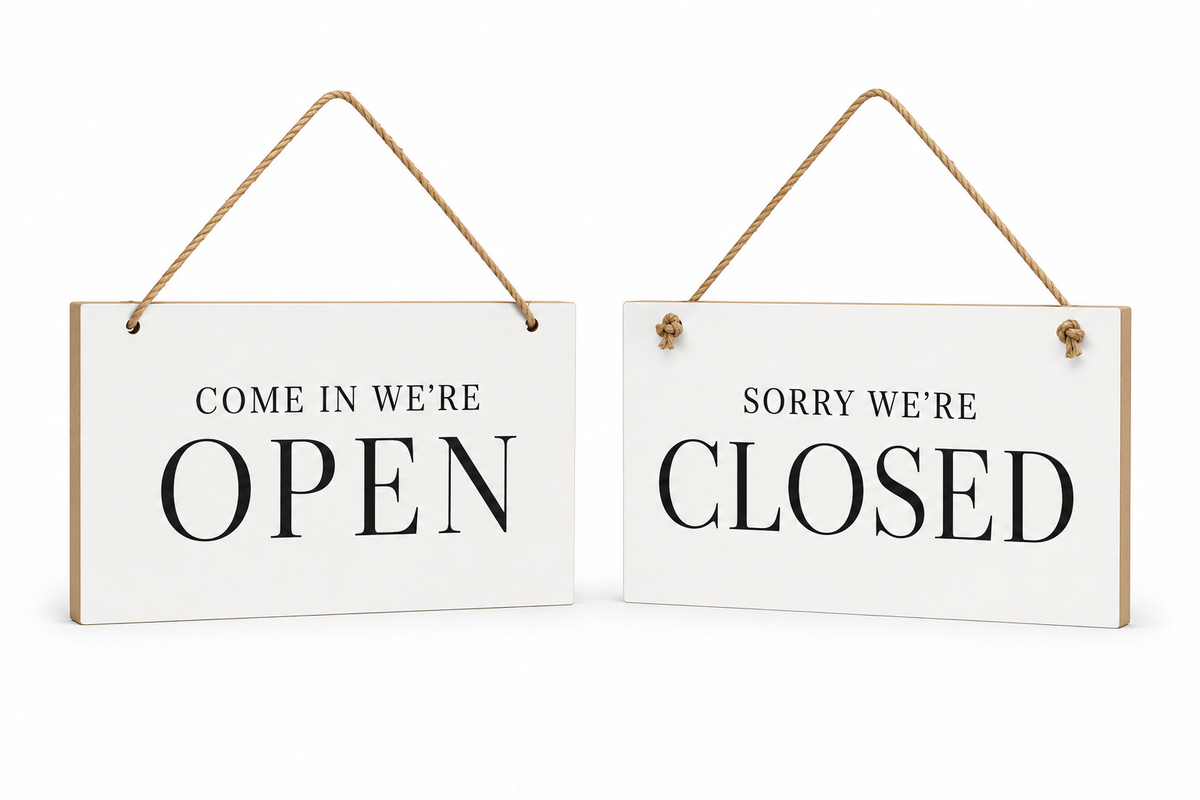 Two white hanging wooden signs with natural wood edges and rope hangers, one reading 'COME IN WE'RE OPEN' and the other reading 'SORRY WE'RE CLOSED', shown on a white background.