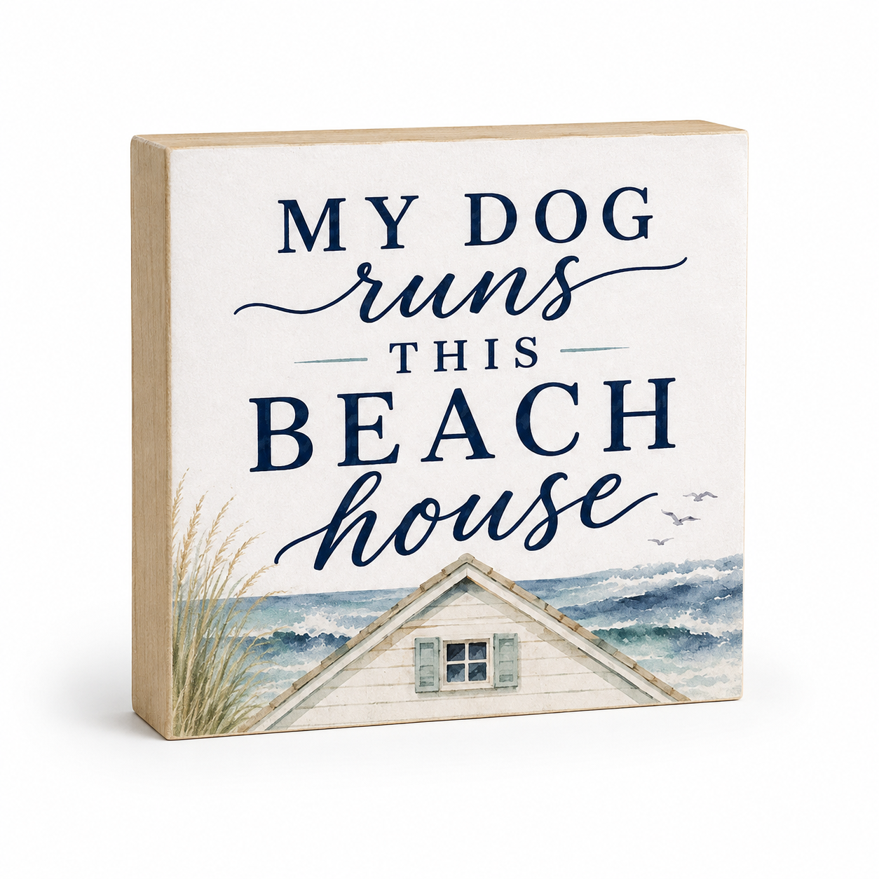 Square decorative wall sign with a light wood edge and a cream front panel that reads “MY DOG runs THIS BEACH house” in navy lettering above a watercolor beach house and ocean scene.