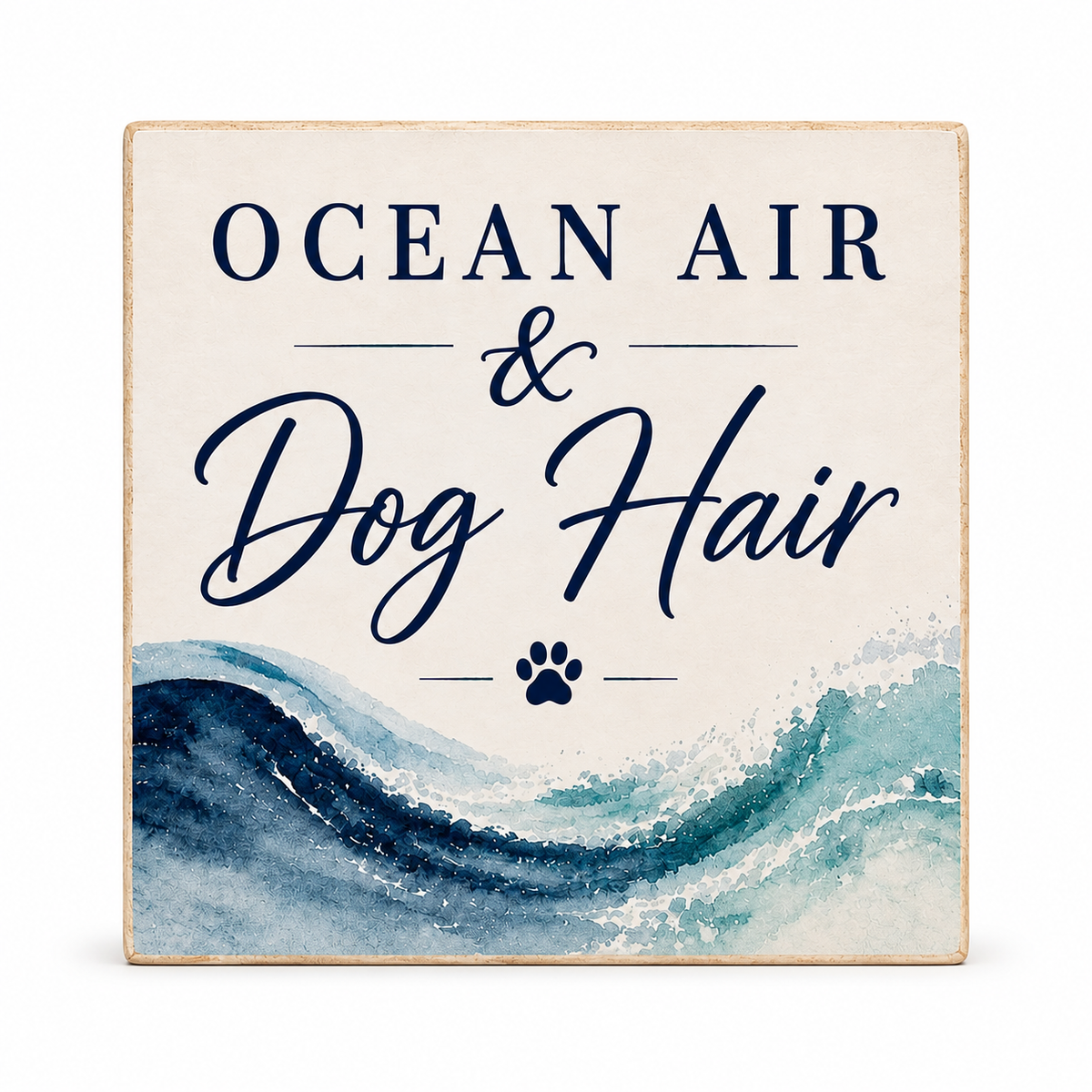 A square decorative sign with a distressed cream background and a watercolor ocean wave design in blue and teal. The text reads 'OCEAN AIR & Dog Hair' with a small paw print below, shown on a clean white background.