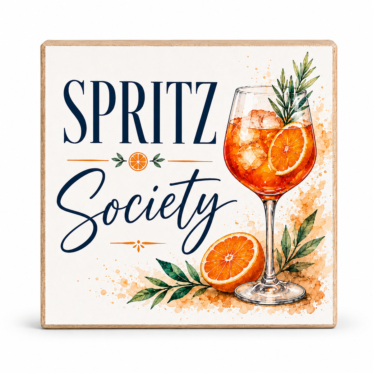 A square decorative sign with a light wood border on a white background. The sign features the text 'SPRITZ Society' in navy blue lettering, accompanied by watercolor illustrations of an orange cocktail in a glass, sliced oranges, green leaves, and orange-brown paint splatters.