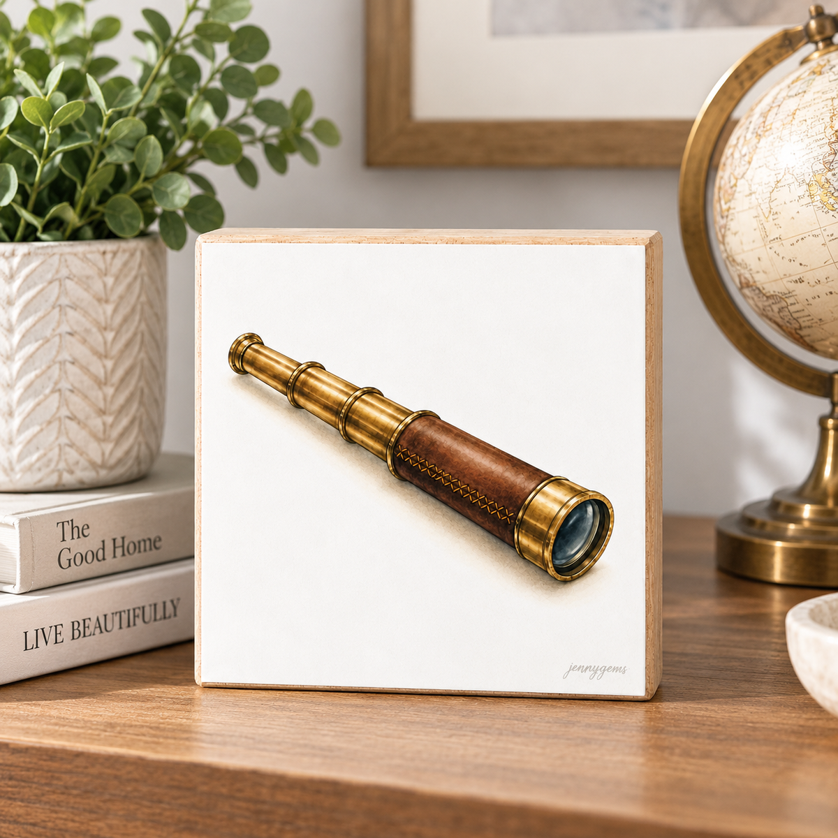 A square white art print or canvas featuring a detailed illustration of a brass telescope with a brown leather handle, displayed on a wooden tabletop next to a potted plant, books, and a globe.