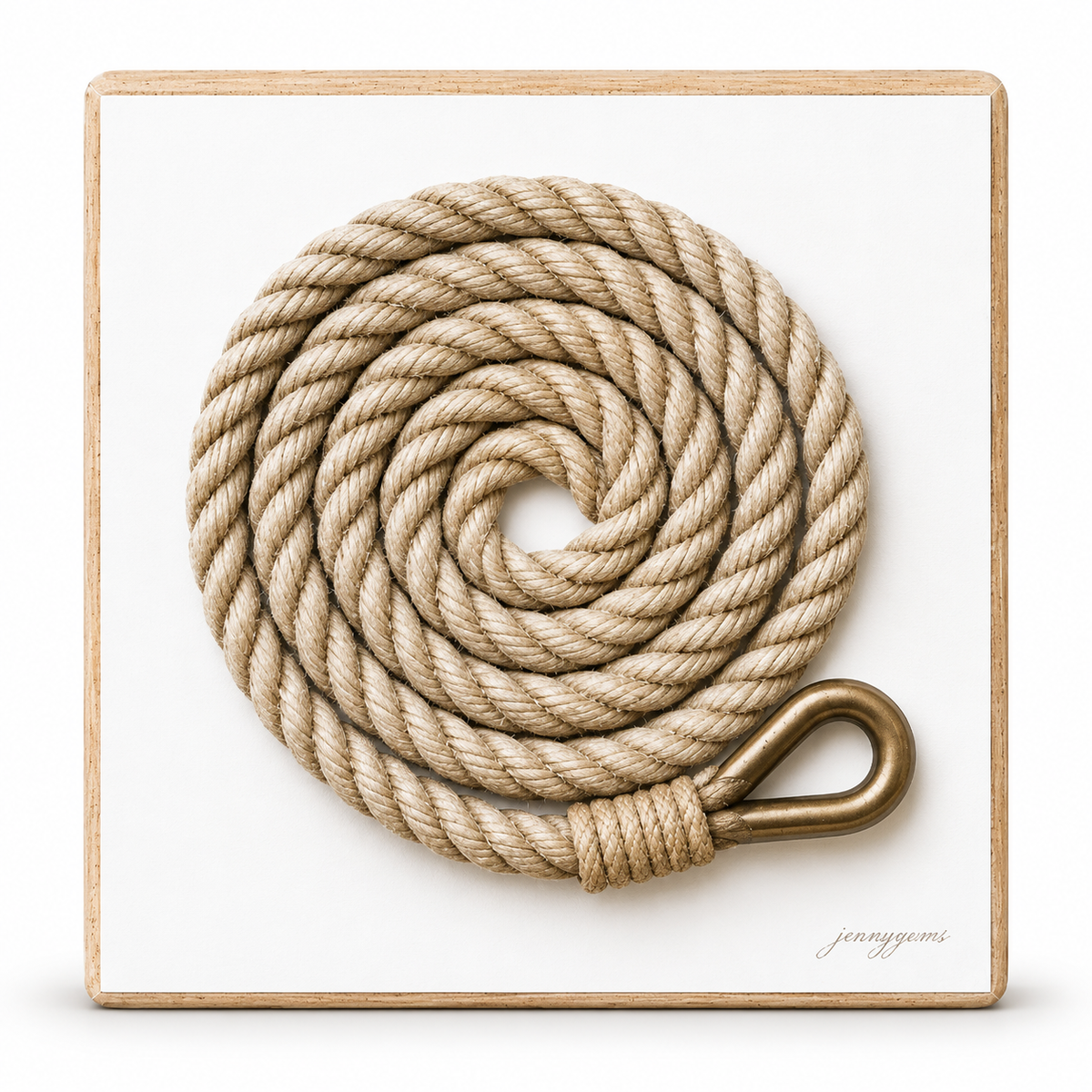 A coiled natural fiber rope with a brass-colored metal loop, mounted on a square white plaque with a light wood border. The brand name 'jeanyomi' is printed in the bottom right corner of the plaque.