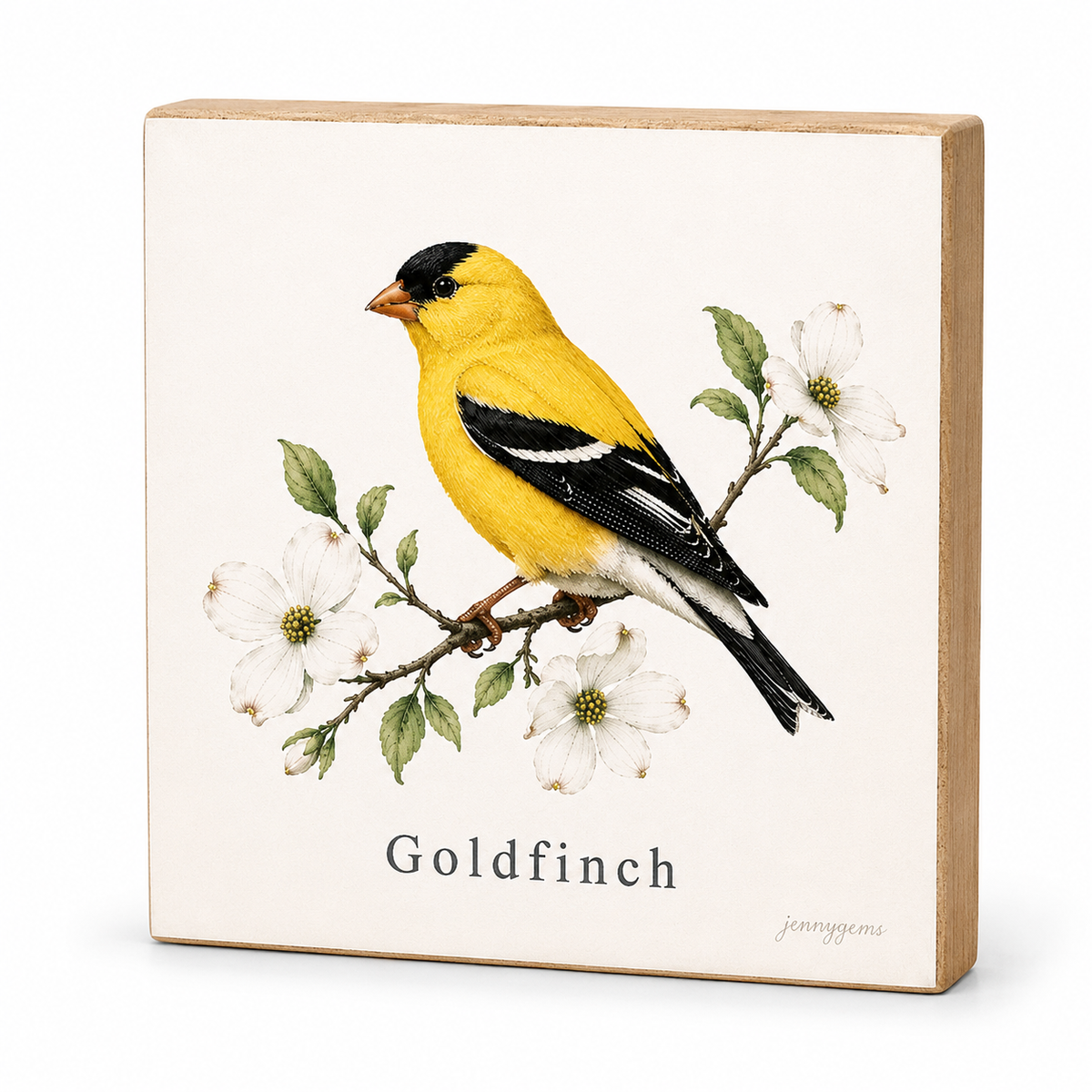 A square decorative block sign featuring a painted goldfinch perched on a branch with white flowers, with the word 'Goldfinch' printed below. The sign has a light wood border and is photographed on a clean white background.