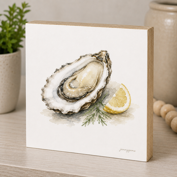 Framed artwork of an oyster and lemon on a white background