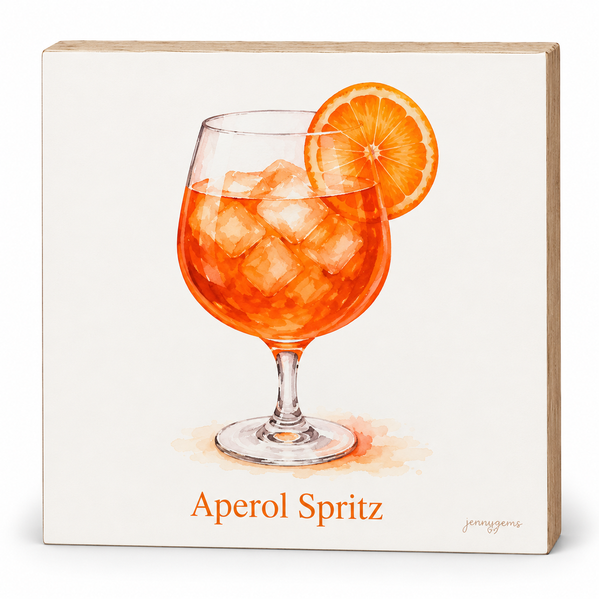 A square decorative wall sign featuring a watercolor-style illustration of an Aperol Spritz cocktail in a stemmed glass with an orange slice garnish, on an off-white background. The words 'Aperol Spritz' appear below in orange text, with a small artist signature in the lower right.