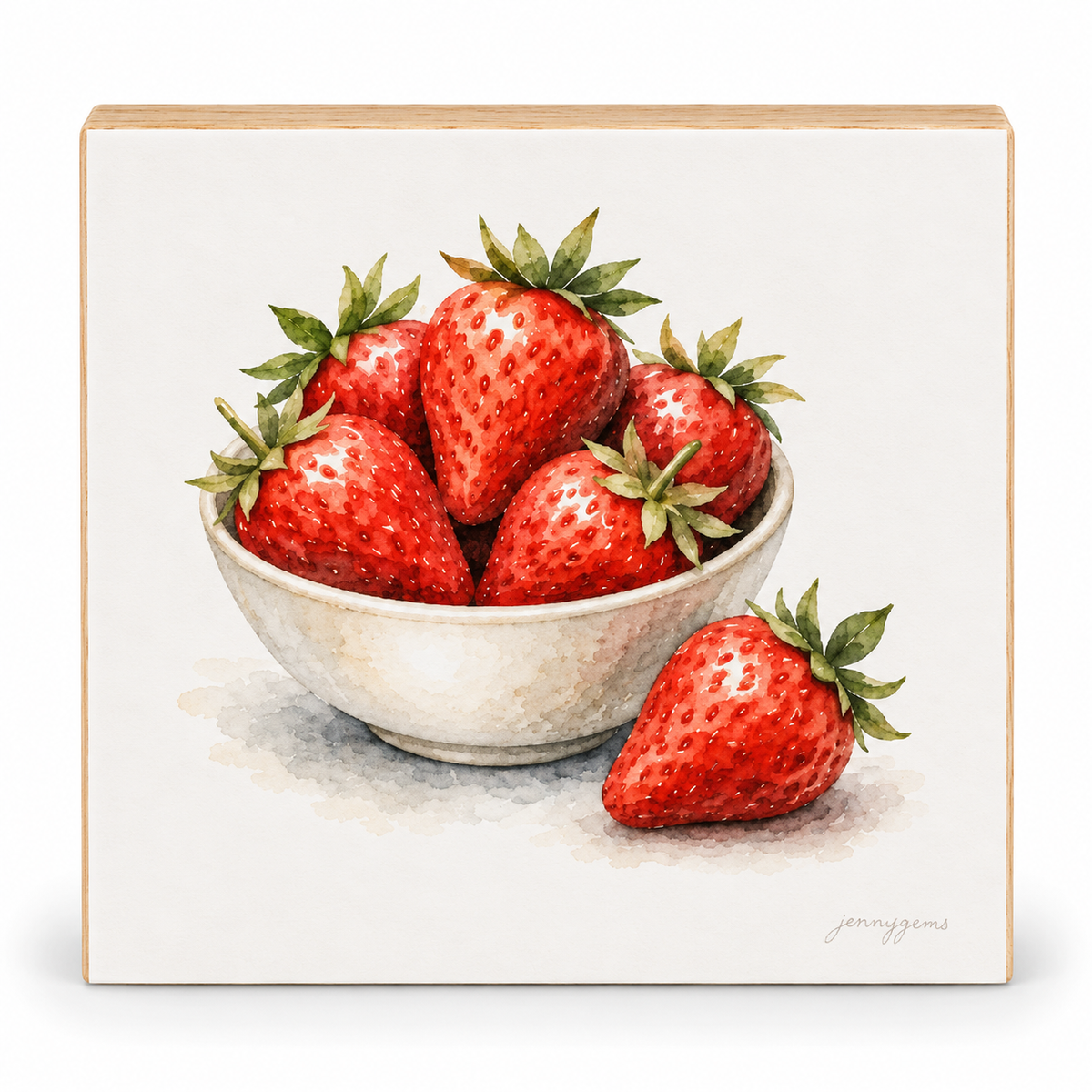 A square decorative sign or plaque featuring a watercolor-style illustration of several red strawberries in a white bowl, with one strawberry placed beside the bowl. The artwork is centered on a light neutral background, and the piece has a natural wood edge visible around the perimeter.
