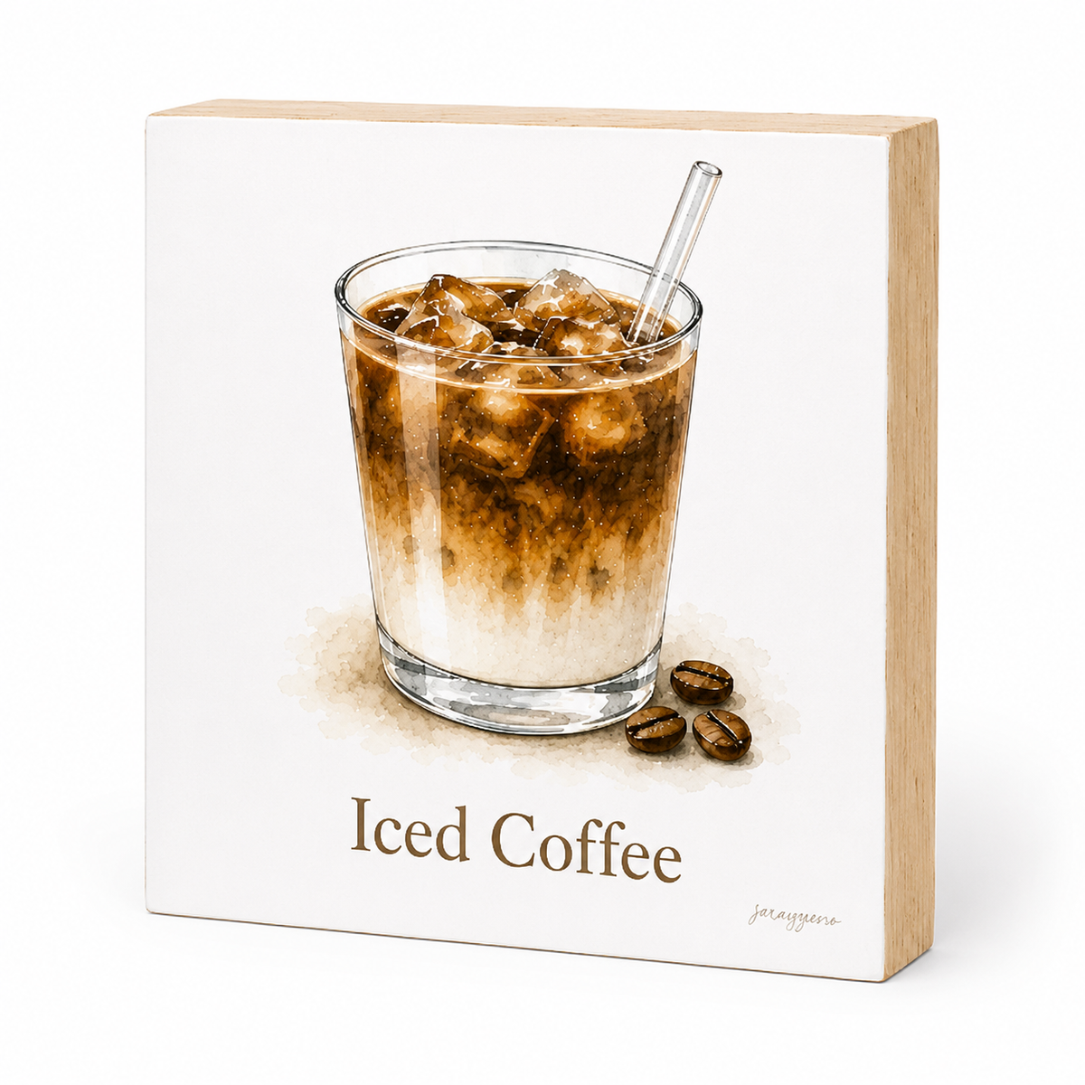 A square wooden sign featuring a watercolor-style illustration of an iced coffee drink in a glass with a straw, plus the words 'Iced Coffee' and a few coffee beans. The sign is photographed on a clean white background.