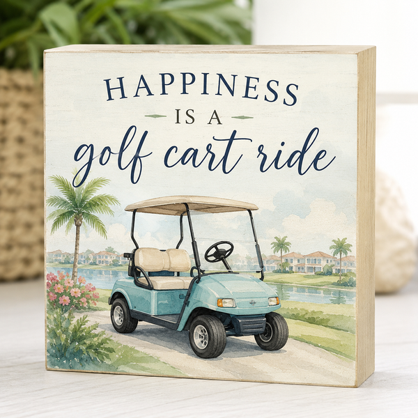 Decorative sign with a golf cart illustration and 'Happiness is a golf cart ride' text.