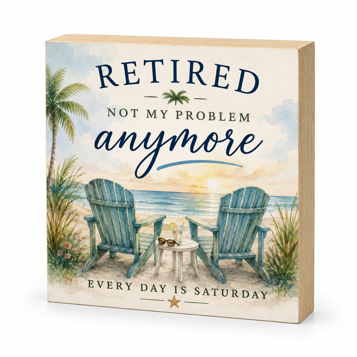 A square wooden decorative sign with a beach scene printed on the front, featuring two blue Adirondack chairs by the ocean and the text 'RETired NOT MY PROBLEM anymore' and 'EVERY DAY IS SATURDAY'.