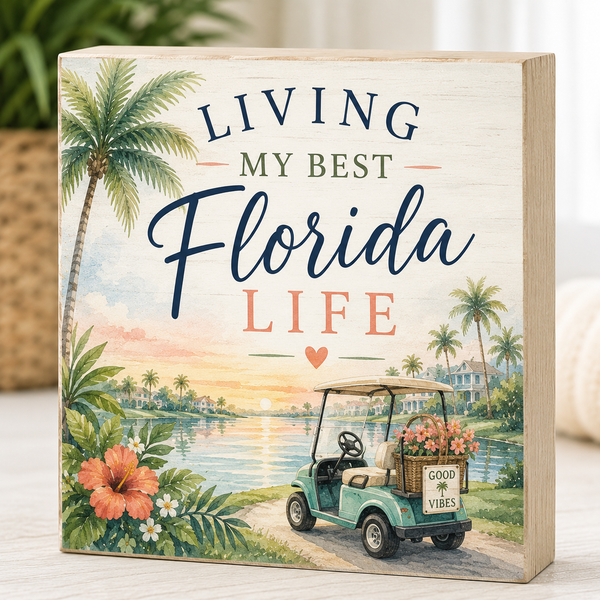 Decorative sign with 'Living My Best Florida Life' text, palm trees, and a golf cart.