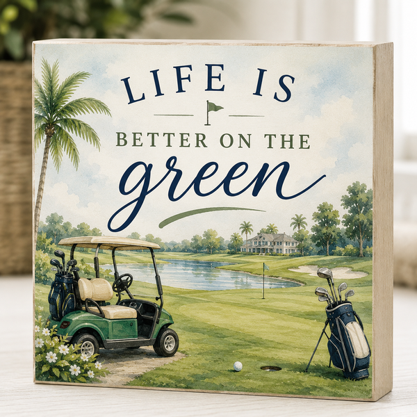 Decorative sign with golf cart and 'Life is Better on the Green' text
