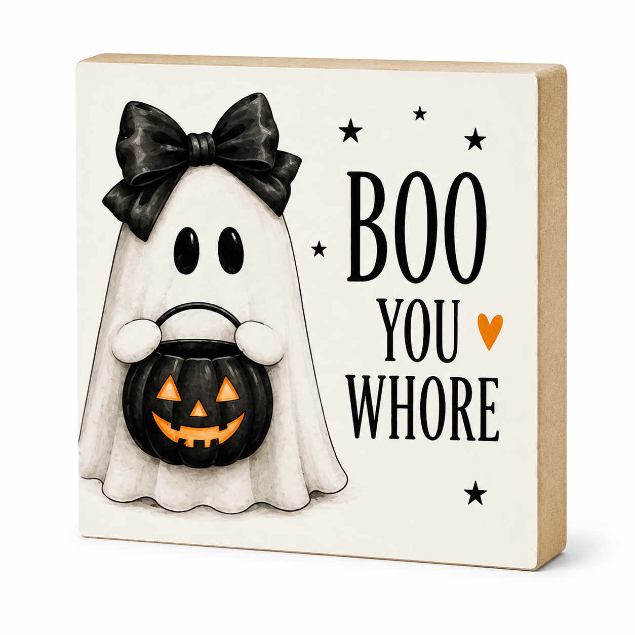 A square decorative sign with a Halloween theme, featuring a cartoon ghost in a black bow holding a jack-o'-lantern bucket, next to the text 'BOO YOU WHORE' with small black stars and an orange heart on a cream background, with a natural wood side edge.