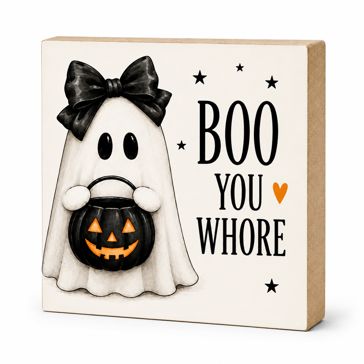 A square Halloween decorative block sign with a cream face-painted wood base, featuring a ghost character in a black bow holding a jack-o'-lantern bucket, next to the text 'BOO YOU WHOR' with small black stars and an orange heart.