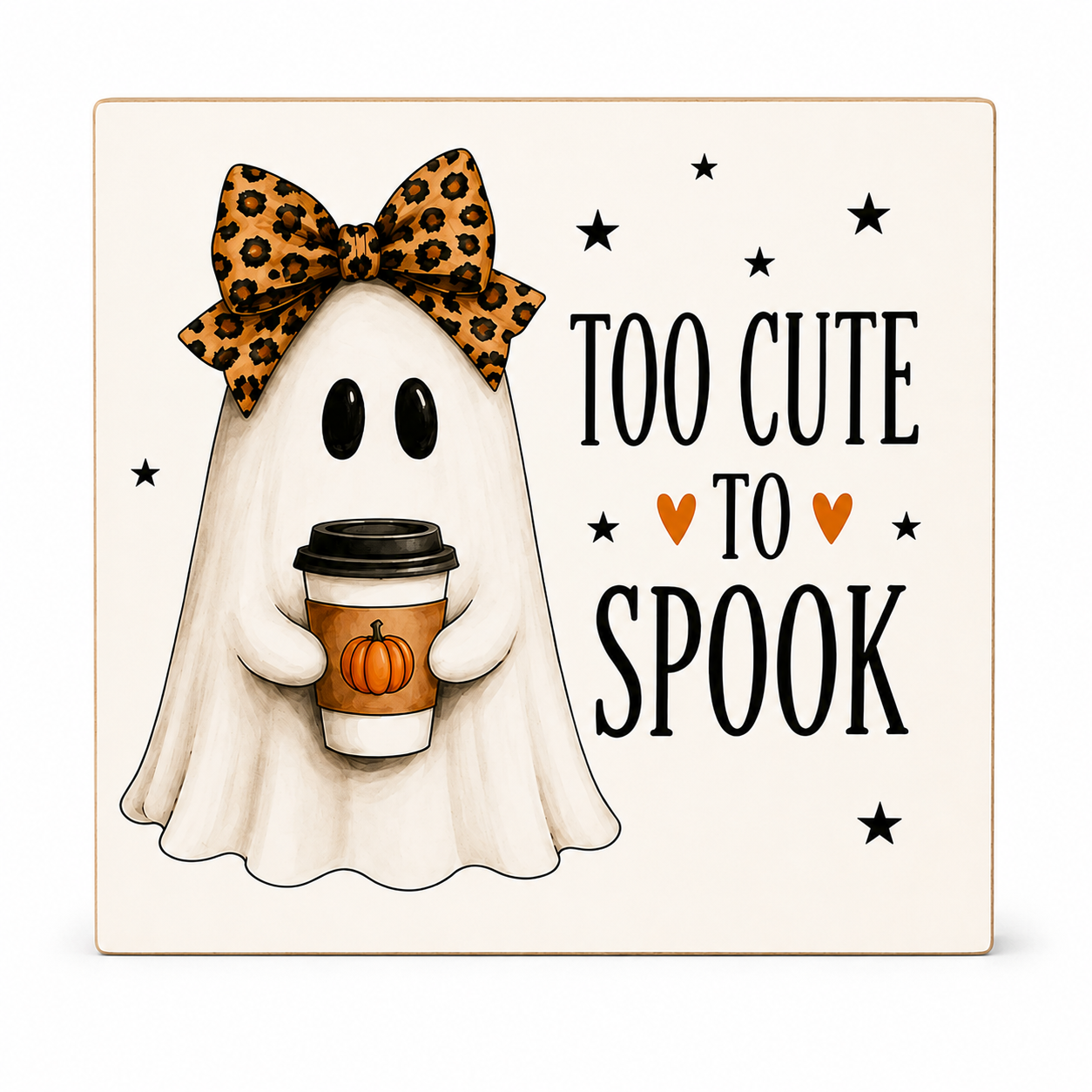 Square decorative sign with a cute ghost illustration wearing a leopard-print bow and holding a coffee cup, next to the text 'TOO CUTE TO SPOOK' with small orange hearts and black stars on a cream background.