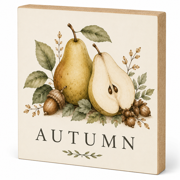 A square decorative wooden sign with a natural wood side edge, featuring an autumn illustration of a whole pear, a halved pear, an acorn, and pinecones with the word 'AUTUMN' printed below.