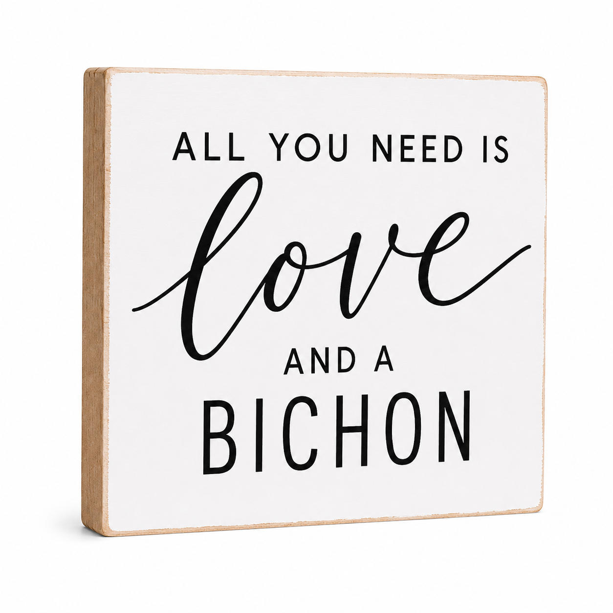 A square decorative wooden sign with a white face and natural wood edges, printed with the phrase 'ALL YOU NEED IS love AND A BICHON' in black lettering, shown on a plain white background.