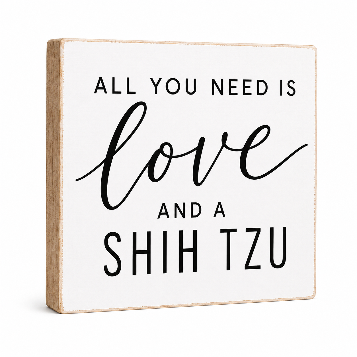 A square decorative wooden sign with a white face and natural wood edges, printed with the phrase 'ALL YOU NEED IS love AND A SHIH TZU' in black lettering, shown on a clean white background.
