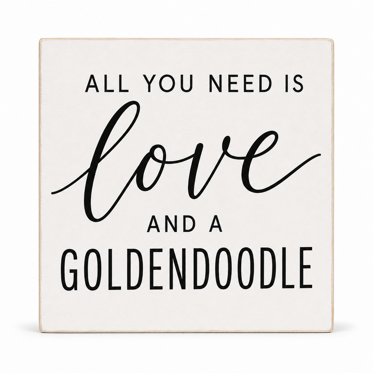 A square decorative sign with a light cream background and black text that reads, 'ALL YOU NEED IS love AND A GOLDENDOODLE.' The word 'love' is written in a large cursive script, while the other text is in a clean sans-serif font.