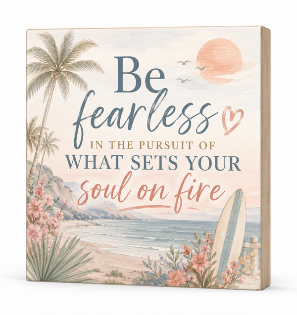 A square decorative wall sign with a beach scene illustration and the phrase “Be fearless in the pursuit of what sets your soul on fire” in blue and peach lettering, shown at a slight angle against a white background.