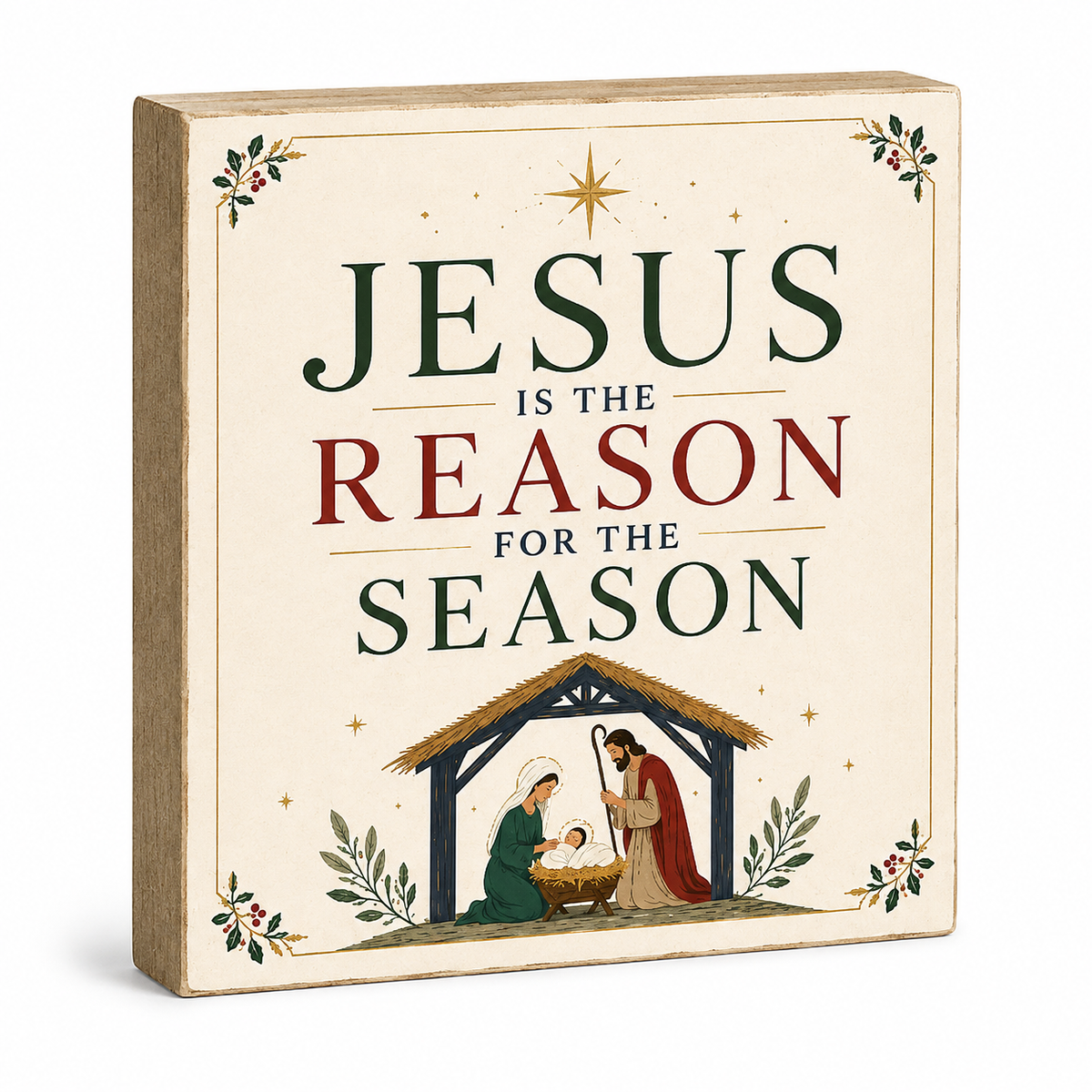 A square decorative sign with a beige background and natural wood edges, featuring the text 'JESUS IS THE REASON FOR THE SEASON' in dark green and burgundy lettering, with a nativity scene illustration at the bottom.