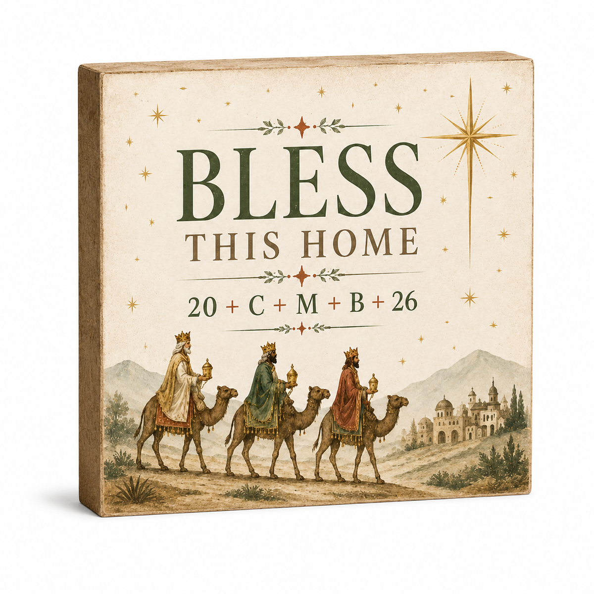 A square decorative wall plaque with a Christmas-themed illustration and the text 'BLESS THIS HOME' plus '20 + C + M + B + 26'. The design shows three wise men on camels with a starry sky and distant castle.