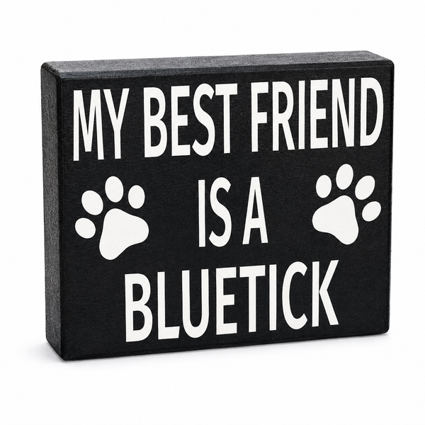 A rectangular black decorative sign with white text reading 'MY BEST FRIEND IS A BLUETICK' and two white paw prints, shown on a plain white background.