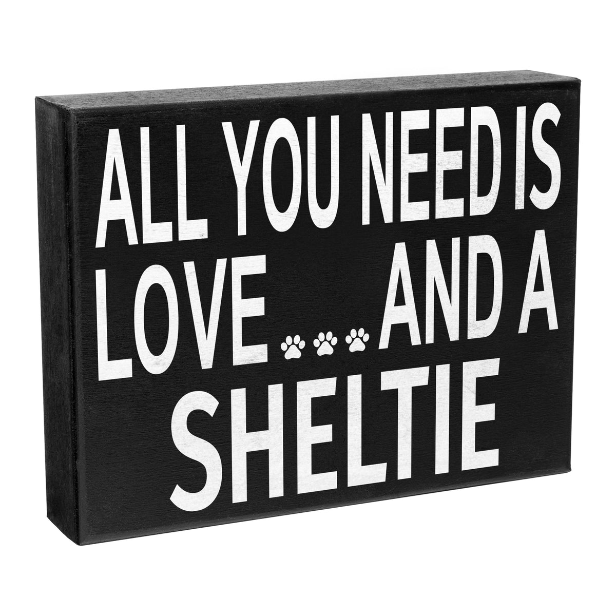 A wooden sign with the text 'All You Need is Love and a Sheltie' and a paw print symbol, meant to represent a Sheltie dog.