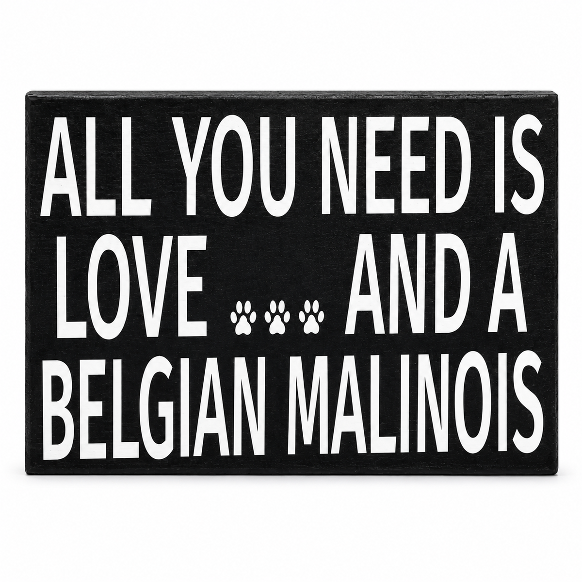 A rectangular black sign with bold white text reading 'ALL YOU NEED IS LOVE .