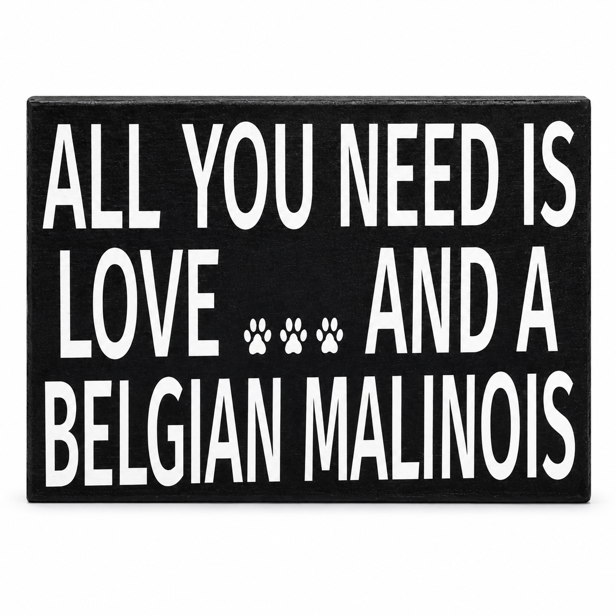 A rectangular black sign with bold white text reading 'ALL YOU NEED IS LOVE .