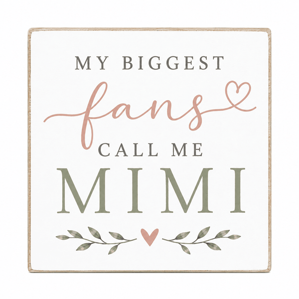 A square decorative sign with a distressed cream background and a light wood border. The text reads 'MY BIGGEST fans CALL ME MIMI' in gray and dusty pink lettering, with small leaf and heart illustrations below.