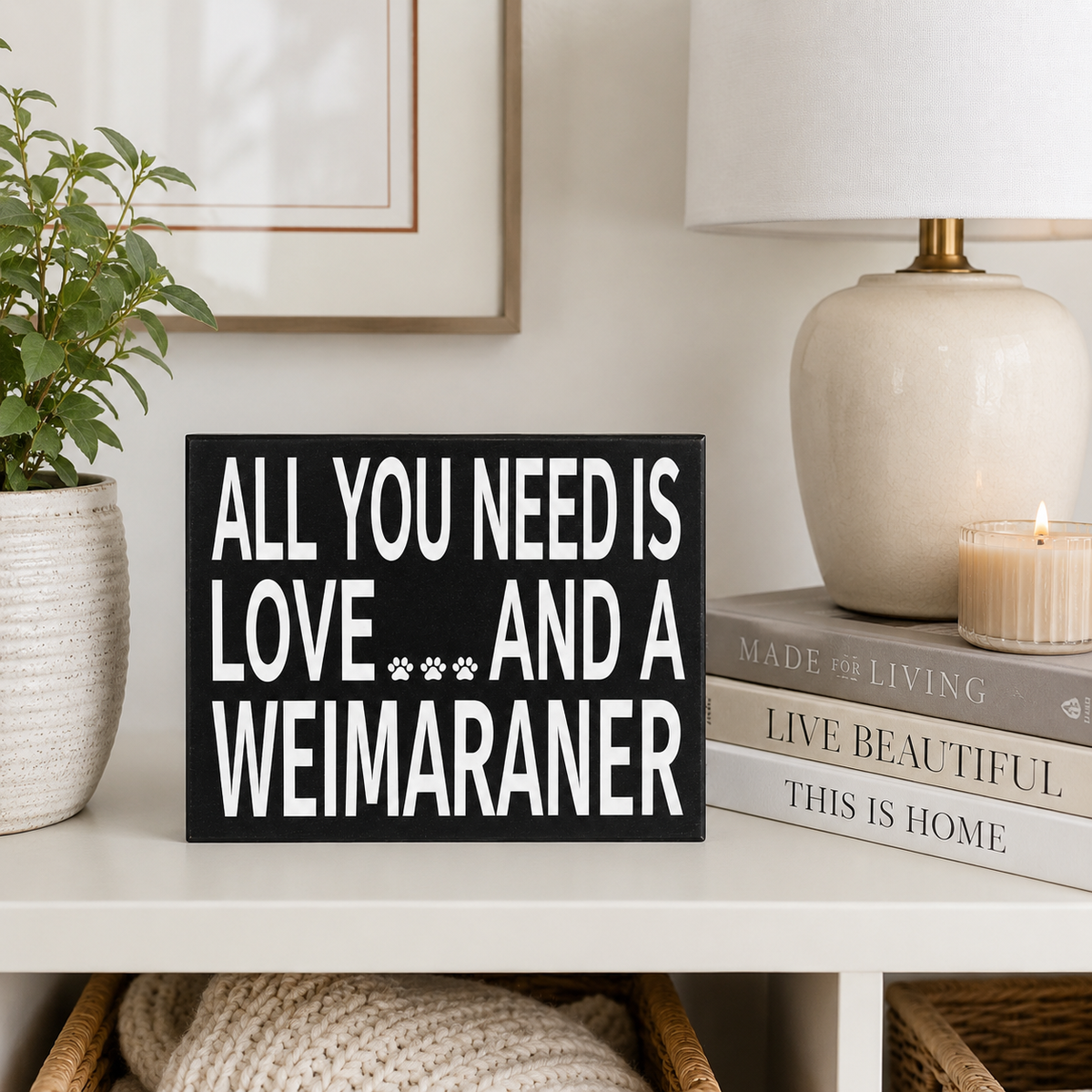A black rectangular sign with bold white text reading 'ALL YOU NEED IS LOVE.