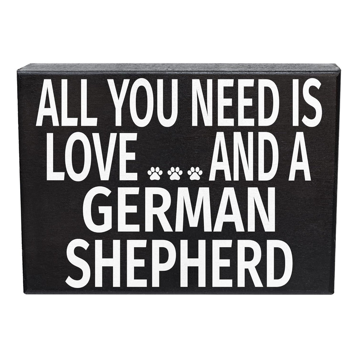 A rectangular black decorative sign with bold white text reading 'ALL YOU NEED IS LOVE.