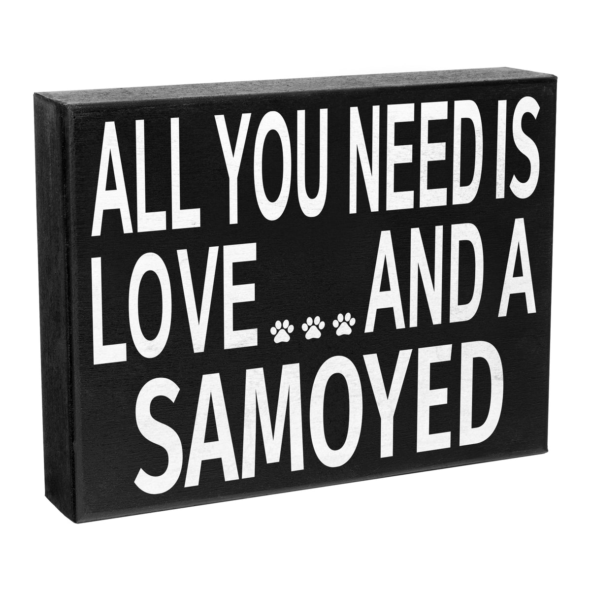 A black wooden stand up box sign with the text 'All You Need is Love and A Love' and a paw print symbol, meant to represent a Samoyed dog.