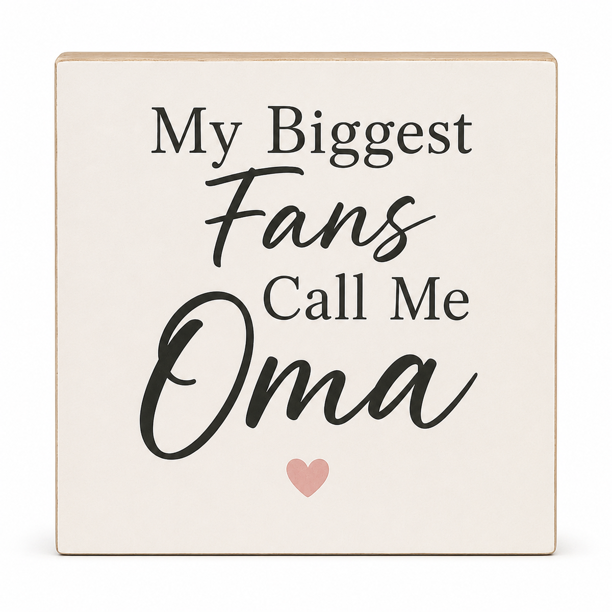 A square decorative sign with a warm off-white face and natural wood edges, featuring the text 'My Biggest Fans Call Me Oma' in black lettering with a small pink heart below, shown on a white background.