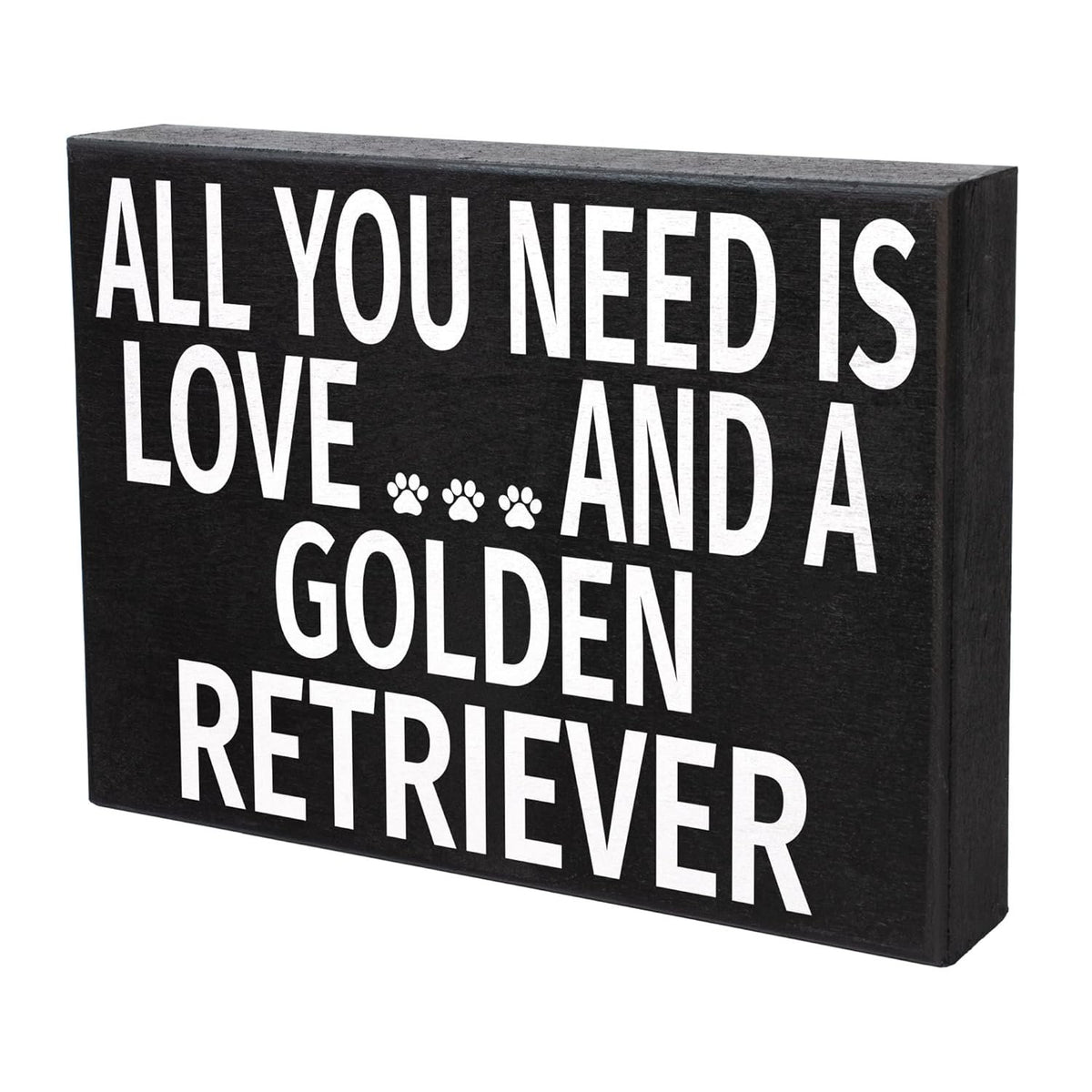 A rectangular black decorative sign with bold white text reading 'ALL YOU NEED IS LOVE.