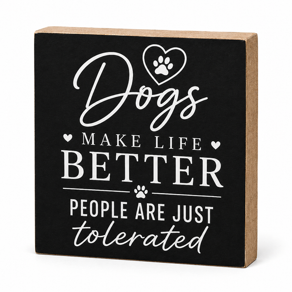 A square decorative wall sign with a black front and natural wood sides, featuring white text that reads “Dogs make life better people are just tolerated” with heart and paw print graphics, shown on a white background.