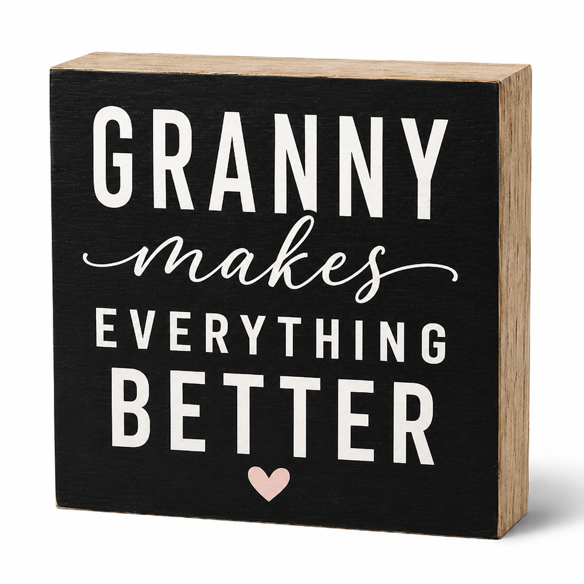 A square decorative wooden sign with a black front panel and natural wood sides. The sign features the phrase 'GRANNY makes EVERYTHING BETTER' in white lettering, with a small light pink heart at the bottom, shown on a clean white background.