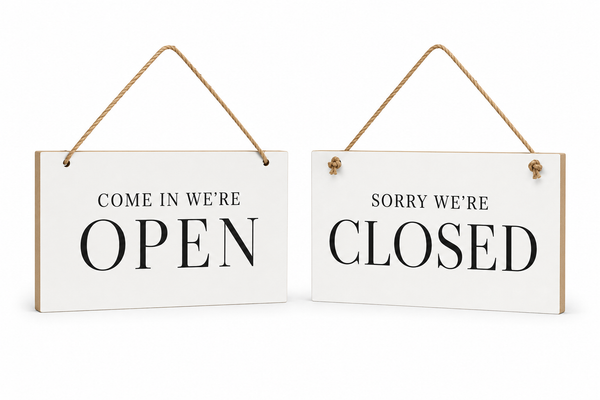 Two white hanging wooden signs with natural wood edges and rope hangers, one reading 'COME IN WE'RE OPEN' and the other reading 'SORRY WE'RE CLOSED', shown on a white background.