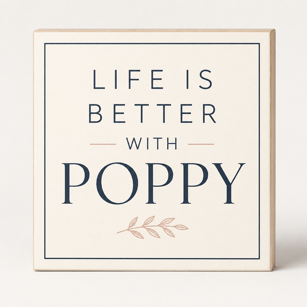 A square decorative sign with a light wood border and cream face that reads “LIFE IS BETTER WITH POPPY” in dark navy lettering, with a small blush pink leaf motif below, shown on a clean light background.