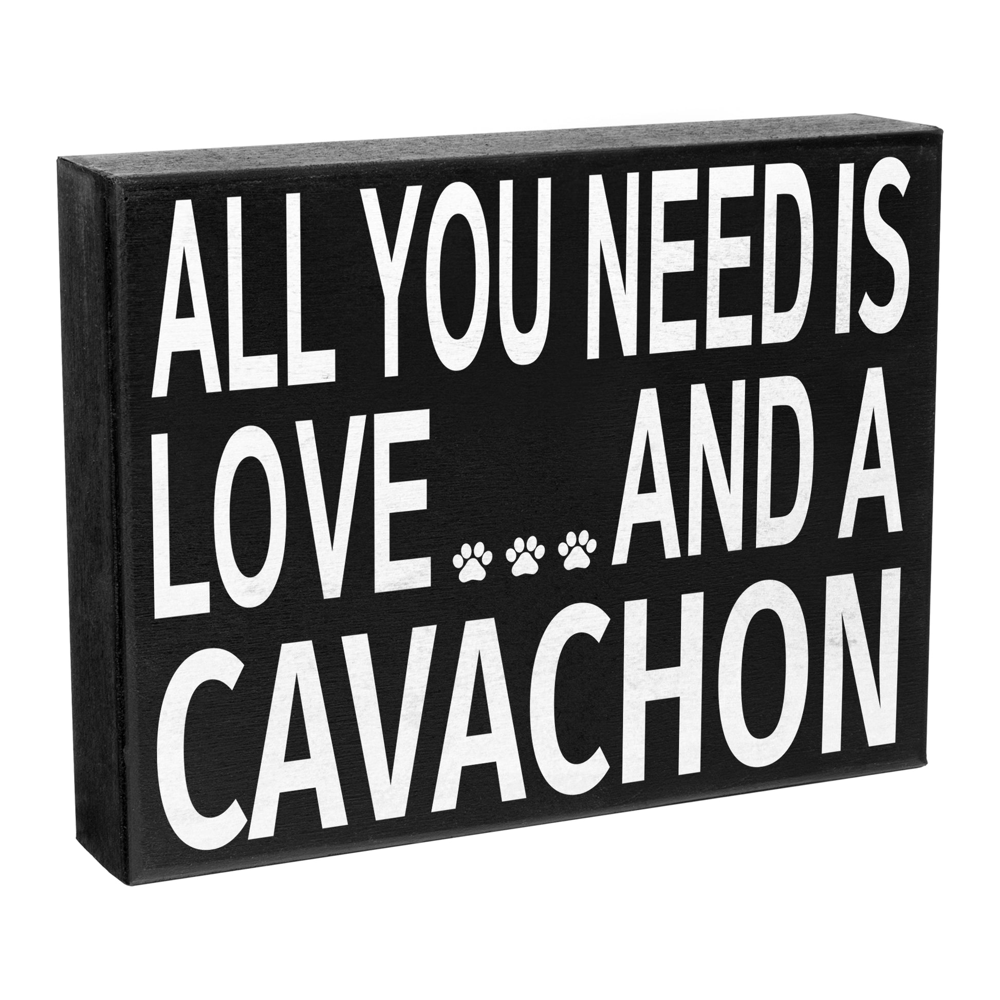 A black wall hanging decor sign with the text 'All you need is LOVE and a CAVACHON' accompanied by paw prints.