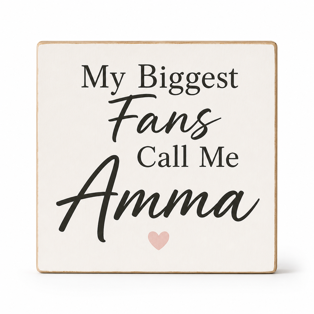 A square decorative sign with a cream face and natural wood edges, printed with the phrase 'My Biggest Fans Call Me Amma' in black lettering and a small light pink heart at the bottom, shown on a white background.