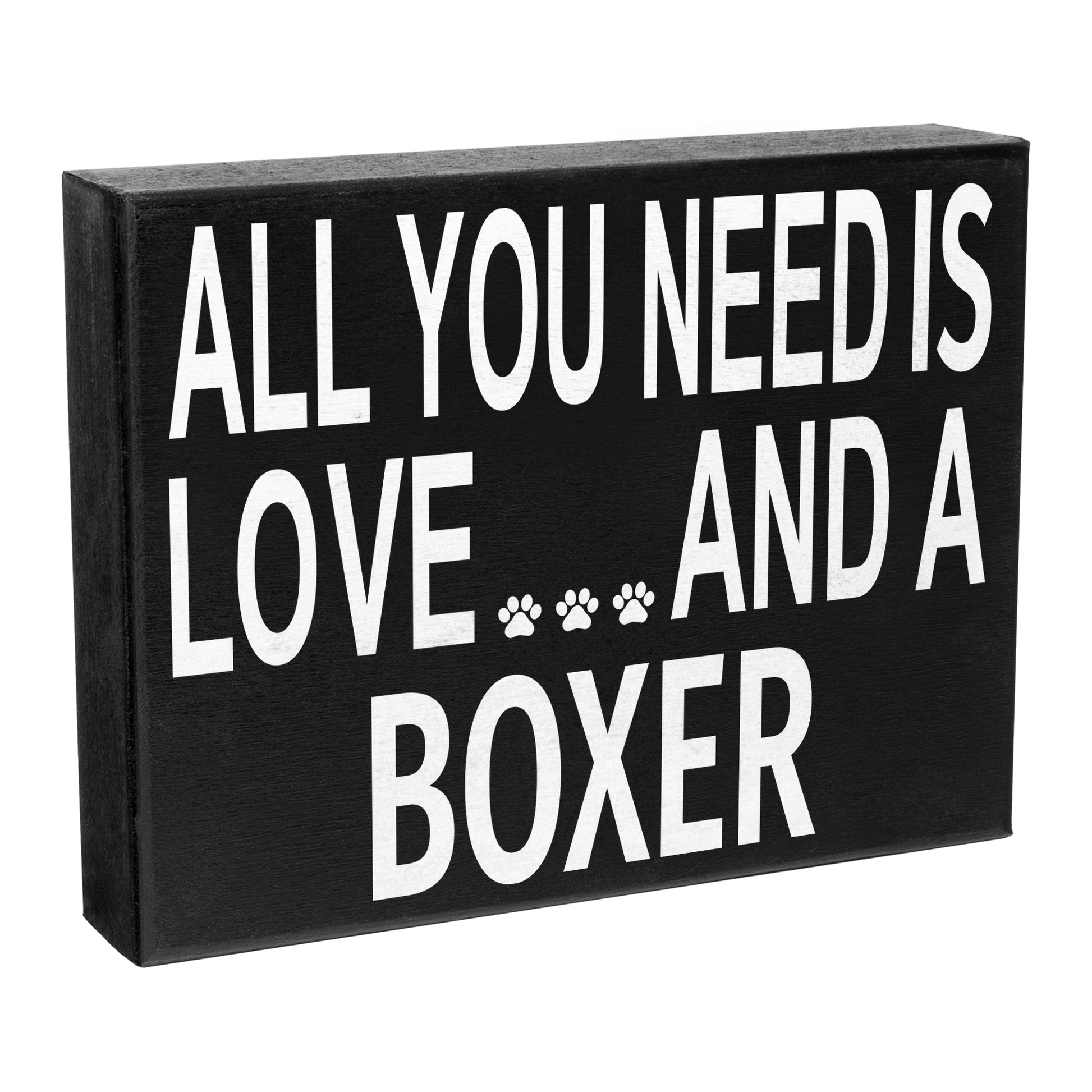 A black wooden sign with the text 'All You Need Is Love AND A BOXER' in white capital letters, featuring a paw print design beside the word 'LOVE'.