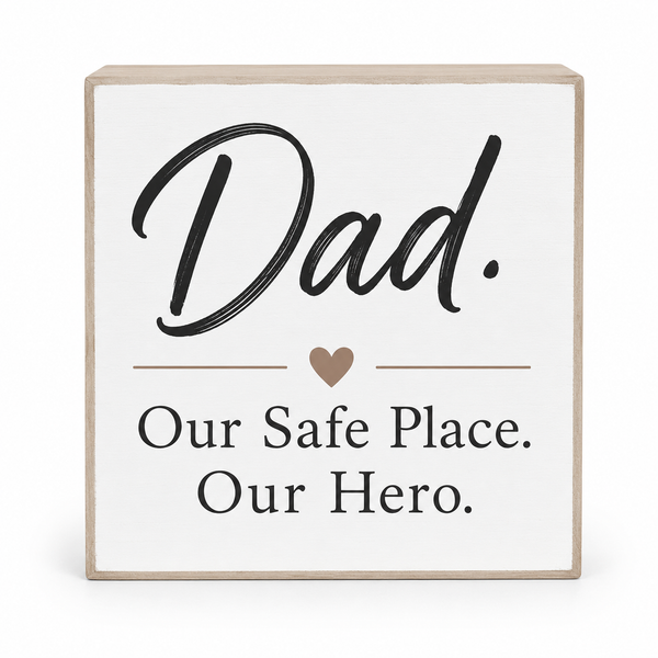 Square wooden sign with a white face and natural wood edges, printed with the words 'Dad. Our Safe Place.