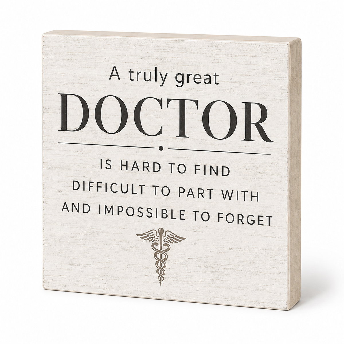 A square decorative wooden sign with a light beige wood-grain finish and black printed text that reads, 'A truly great DOCTOR IS HARD TO FIND DIFFICULT TO PART WITH AND IMPOSSIBLE TO FORGET,' plus a small caduceus symbol near the bottom, shown on a white background.