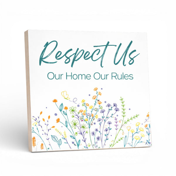 Decorative sign with floral design and text on a white background