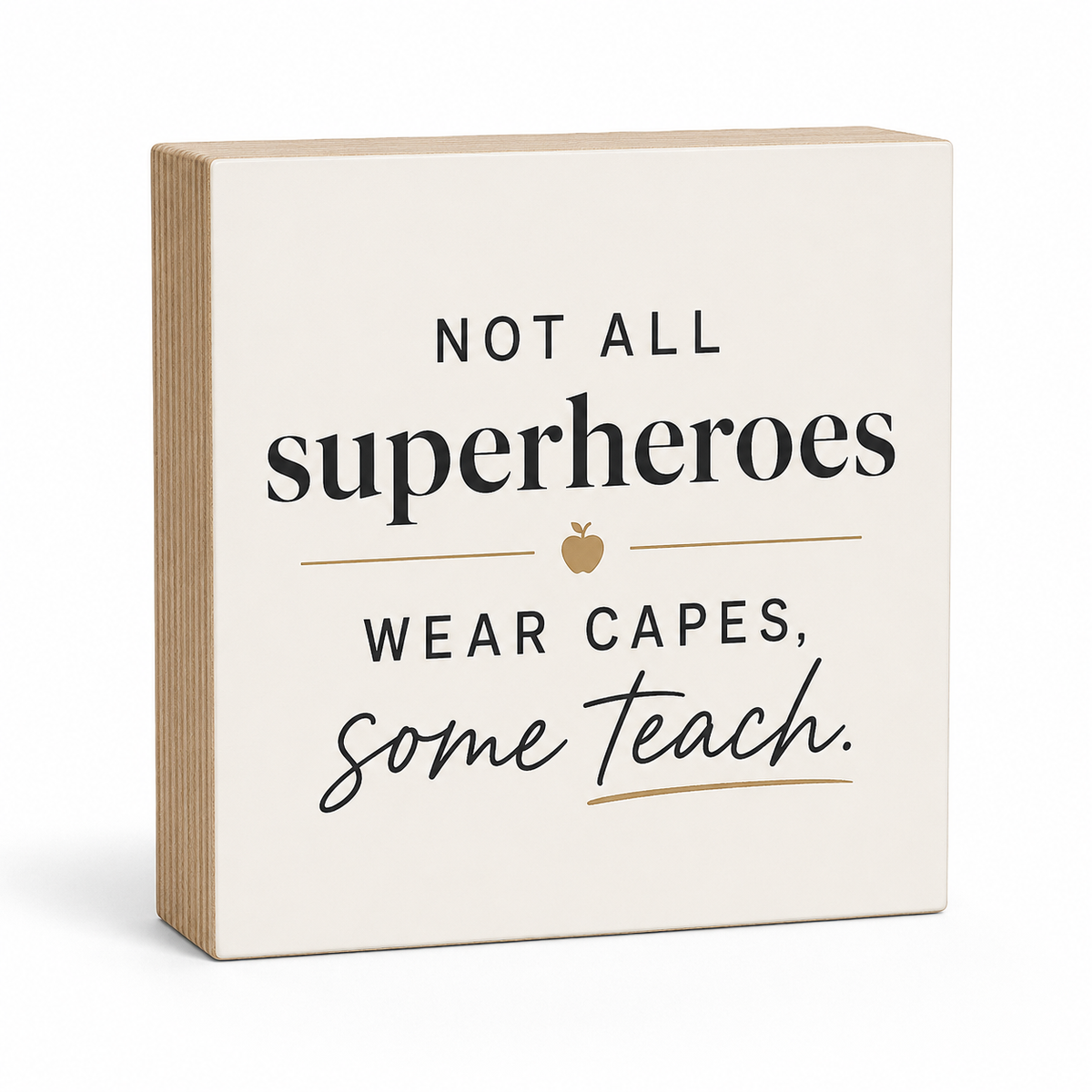 A square decorative wooden sign with a warm cream face and natural light wood sides, featuring the printed quote 'NOT ALL superheroes WEAR CAPES, some teach.' in black text with a small gold apple icon, shown on a white background.