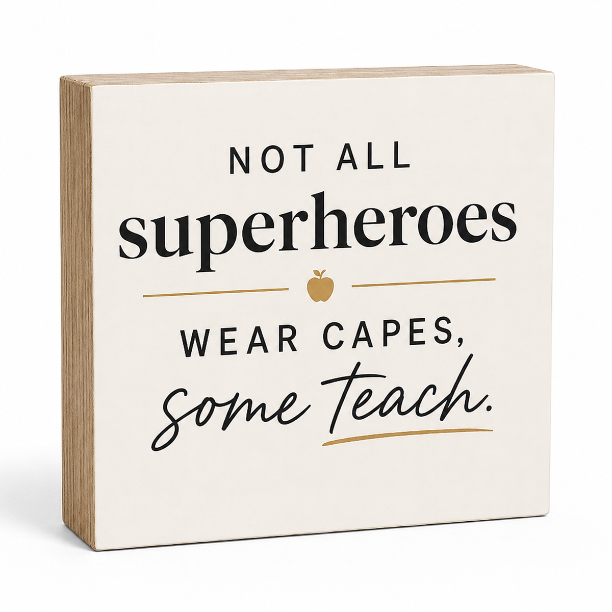 A square decorative wooden sign with a cream face and natural wood edges, printed with the phrase 'NOT ALL superheroes WEAR CAPES, some teach.' in black and cursive lettering with small gold apple and line accents, shown on a white background.
