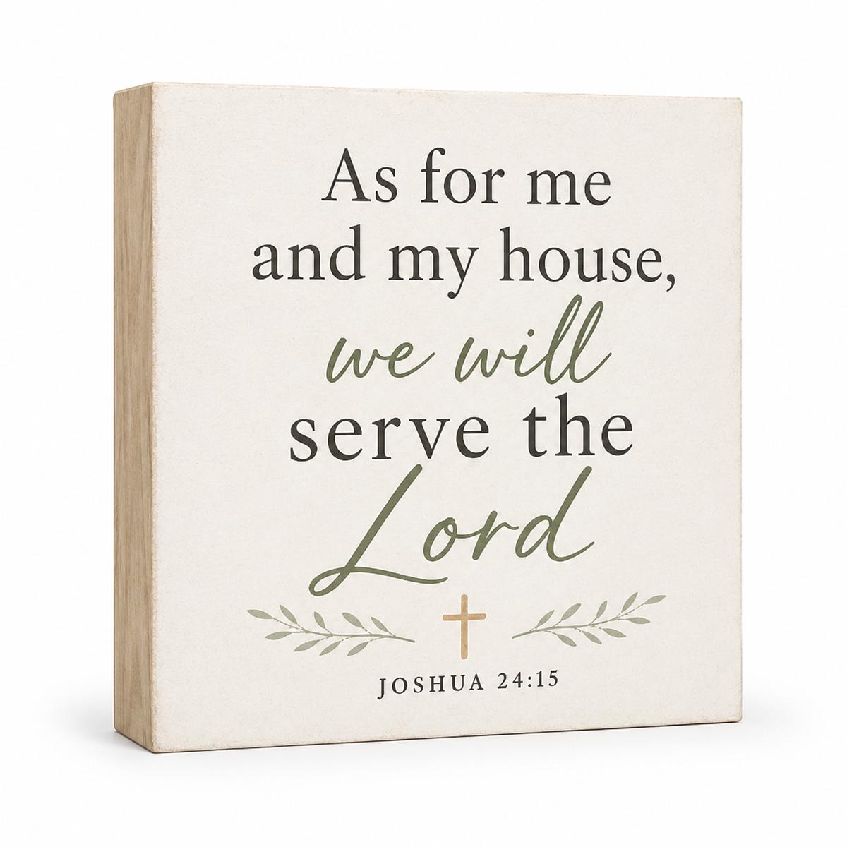 A square decorative wall sign with a light wood side edge and a cream front panel. The front features the Bible verse 'As for me and my house, we will serve the Lord Joshua 24:15' in dark gray and muted sage green lettering, with a small tan cross and leaf motif.