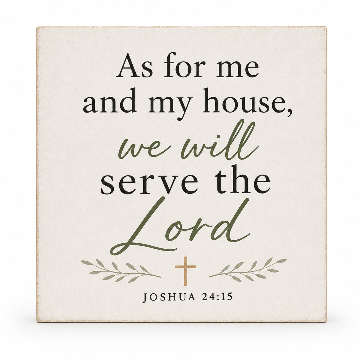 A square decorative wall sign with a warm off-white background and printed Bible verse text reading 'As for me and my house, we will serve the Lord Joshua 24:15.' The words 'we will' and 'Lord' are in olive green script, with a small olive-green cross and leafy accents.
