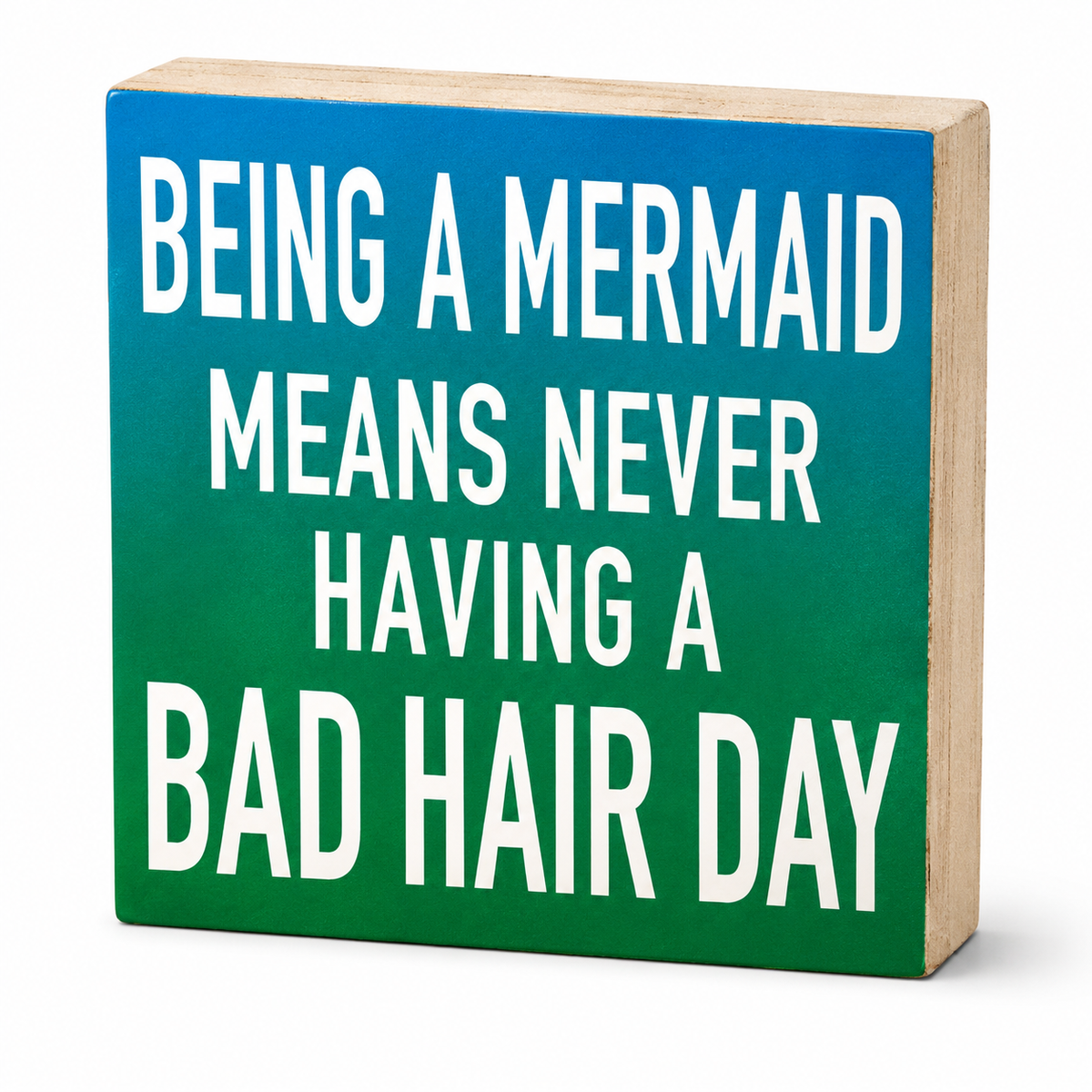 A square wooden sign with a blue-to-green gradient face and bold white text reading 'BEING A MERMAID MEANS NEVER HAVING A BAD HAIR DAY', shown on a clean white background.